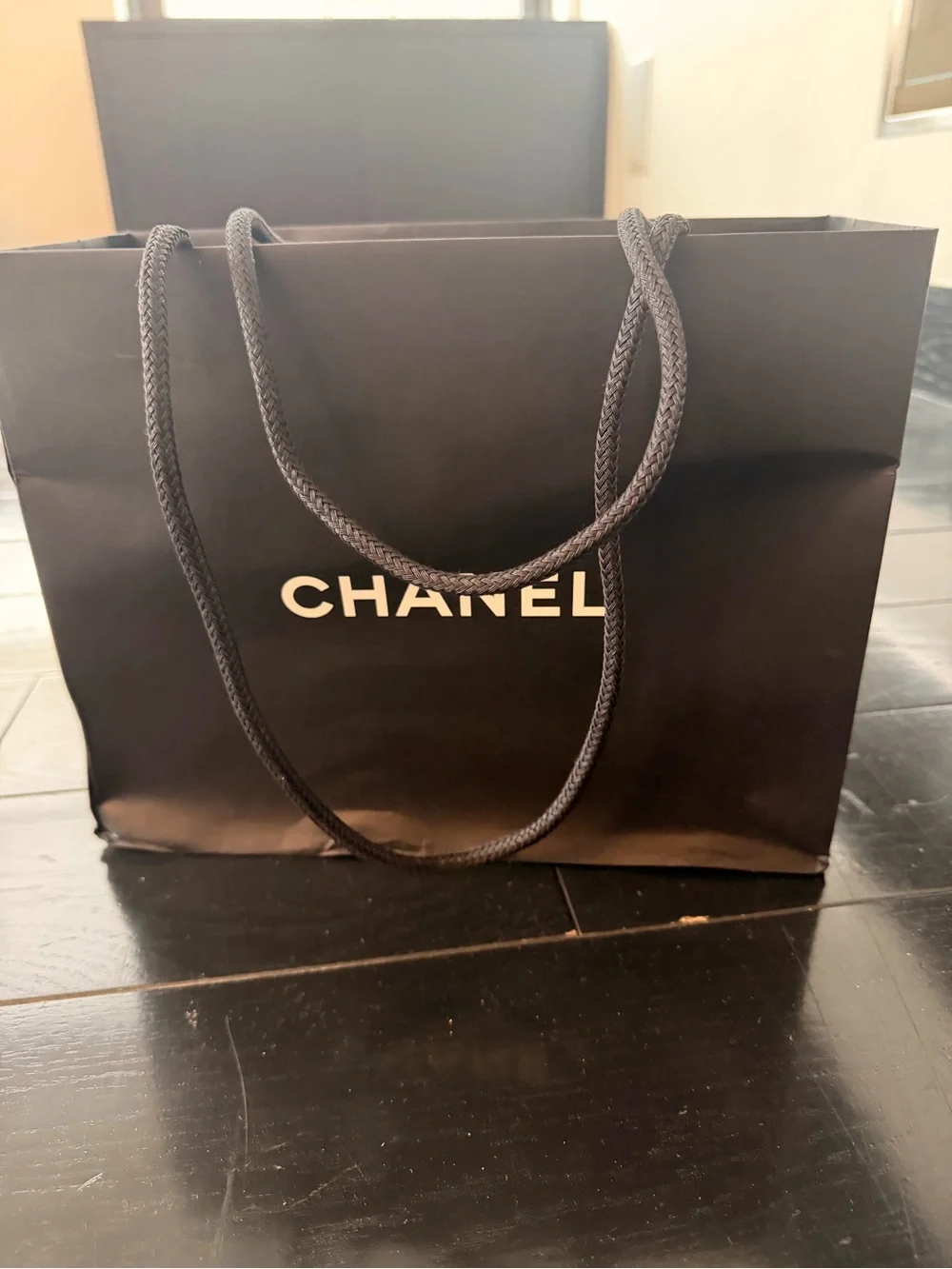 CHANEL Black bag (12” x 9”) with sticker flower accent